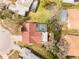 Overhead shot of home with red brick roof, screened in pool, and spacious backyard at 13542 Summerwood Ct, Hudson, FL 34667
