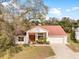Aerial view of a single-story home with well-maintained landscaping and a two car garage at 13542 Summerwood Ct, Hudson, FL 34667