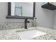 Close-up of bathroom vanity with granite countertop and decorative mirror at 13542 Summerwood Ct, Hudson, FL 34667