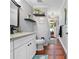 Full bathroom with granite counters, decorative mirror, and tiled floors at 13542 Summerwood Ct, Hudson, FL 34667