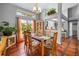 Open dining room area featuring large windows and backyard views at 13542 Summerwood Ct, Hudson, FL 34667