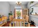 Dining room featuring a large window, chandelier, and views of the backyard at 13542 Summerwood Ct, Hudson, FL 34667