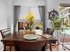 Cozy dining area with a wooden table and chairs, bathed in natural light from the window at 13542 Summerwood Ct, Hudson, FL 34667