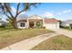 Charming single-story home featuring a well-manicured lawn and a cozy front porch at 13542 Summerwood Ct, Hudson, FL 34667
