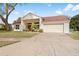 Inviting single-story home showcasing a two-car garage and manicured landscaping at 13542 Summerwood Ct, Hudson, FL 34667