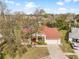 Charming single-story home featuring a red roof, a spacious driveway and mature trees enhancing its curb appeal at 13542 Summerwood Ct, Hudson, FL 34667