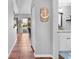 Hallway with brown tiled floor leading to bathroom and back porch at 13542 Summerwood Ct, Hudson, FL 34667