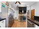 Stylish kitchen with stainless steel refrigerator, tile floors, and nearby dining area at 13542 Summerwood Ct, Hudson, FL 34667