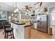 Spacious kitchen with stainless steel appliances, breakfast bar, tile floors, and easy living room access at 13542 Summerwood Ct, Hudson, FL 34667