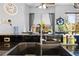 Close-up of kitchen sink area, featuring modern faucet, tile backsplash, and bright window at 13542 Summerwood Ct, Hudson, FL 34667