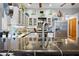 Bright kitchen with stainless steel appliances, sleek countertops, and modern fixtures at 13542 Summerwood Ct, Hudson, FL 34667