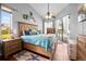 Bright bedroom boasts stylish furniture, vaulted ceilings, and access to the pool area at 13542 Summerwood Ct, Hudson, FL 34667