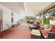 Relaxing screened patio with seating area perfect for enjoying the outdoors at 13542 Summerwood Ct, Hudson, FL 34667