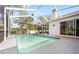 Screened in pool with outdoor furniture and clear sliding glass door at 13542 Summerwood Ct, Hudson, FL 34667