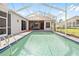 Backyard screened in pool with ladder surrounded by patio area and chairs at 13542 Summerwood Ct, Hudson, FL 34667