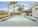 Backyard screened in pool with clear water and blue trim surrounded by trees and houses at 13542 Summerwood Ct, Hudson, FL 34667