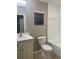 This bathroom features a white vanity, toilet, and shower with tile surround at 1914 E 4Th Ave # 2, Tampa, FL 33605