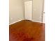 An empty bedroom features gleaming hardwood floors and a white closet door at 1914 E 4Th Ave # 2, Tampa, FL 33605