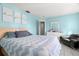 Spacious bedroom featuring tile floors, blue walls, and ample natural light at 1942 Radcliffe N Dr, Clearwater, FL 33763