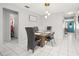 Light and airy dining room with modern lighting, tile flooring and a decorative wall sign at 1942 Radcliffe N Dr, Clearwater, FL 33763