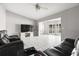 Bright living room featuring neutral walls, tile flooring, a ceiling fan and large windows for ample natural light at 1942 Radcliffe N Dr, Clearwater, FL 33763