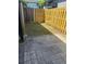 Private back yard has both a stone patio and a grassy area with a tall fence at 204 Pine Tulip Ct # 102, Tampa, FL 33612