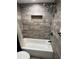 A tub with dual shower heads and tile surround provides an oasis in this updated bathroom at 204 Pine Tulip Ct # 102, Tampa, FL 33612