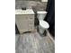 This bathroom includes a modern vanity, toilet, and wood-look tiled floor at 204 Pine Tulip Ct # 102, Tampa, FL 33612