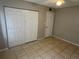 Bedroom features a large closet, neutral paint, tile floors and a ceiling fan at 204 Pine Tulip Ct # 102, Tampa, FL 33612