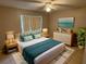 Cozy bedroom with a ceiling fan, lots of pillows and natural light, creating a serene retreat at 204 Pine Tulip Ct # 102, Tampa, FL 33612