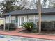 Exterior view of the clubhouse with manicured shrubs and nearby parking at 204 Pine Tulip Ct # 102, Tampa, FL 33612