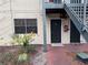 This is the entrance to unit 102 featuring neutral paint, well maintained landscape, and an access door at 204 Pine Tulip Ct # 102, Tampa, FL 33612