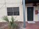 Exterior front door of apartment with a window and fire alarm system at 204 Pine Tulip Ct # 102, Tampa, FL 33612