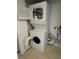 Stacked washer and dryer, with open dryer door at 204 Pine Tulip Ct # 102, Tampa, FL 33612