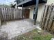 Enclosed back patio with a small yard surrounded by a wooden fence at 204 Pine Tulip Ct # 102, Tampa, FL 33612