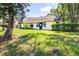 This home has a well-maintained backyard, sliding glass door and lush landscaping at 2201 Pine Dr, Tarpon Springs, FL 34689