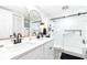 Bright bathroom featuring a double sink vanity, sleek black hardware, and modern glass-enclosed shower at 2201 Pine Dr, Tarpon Springs, FL 34689