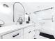 Modern bathroom featuring a single sink vanity, sleek black hardware, and glass-enclosed shower at 2201 Pine Dr, Tarpon Springs, FL 34689