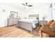 Comfortable bedroom with light wood floors, a ceiling fan, and neutral-toned furniture at 2201 Pine Dr, Tarpon Springs, FL 34689