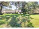 Scenic view of building exteriors surrounded by lush landscaping and mature trees at 2201 Pine Dr, Tarpon Springs, FL 34689