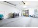 Large garage with laundry appliances, a sink, storage shelves, and garage door at 2201 Pine Dr, Tarpon Springs, FL 34689