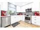 Modern kitchen features white cabinets, stainless steel appliances, and a bright window over the sink at 2201 Pine Dr, Tarpon Springs, FL 34689