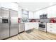 Stylish kitchen boasting stainless steel appliances, white cabinets, and gray tile backsplash for modern appeal at 2201 Pine Dr, Tarpon Springs, FL 34689