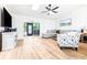 Bright living room features wood-look floors, skylights, and a ceiling fan for a comfortable and inviting space at 2201 Pine Dr, Tarpon Springs, FL 34689