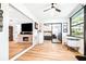 Open-concept living with an office area leading to a bedroom, all featuring modern flooring at 2201 Pine Dr, Tarpon Springs, FL 34689