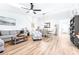 Open floor plan showcases living and dining spaces with wood-look floors and plenty of natural light at 2201 Pine Dr, Tarpon Springs, FL 34689