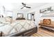 Comfortable main bedroom boasts a plush bed, dresser, and ample natural light for a serene setting at 2201 Pine Dr, Tarpon Springs, FL 34689
