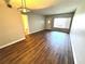 Living room featuring hardwood floors, a modern light fixture, neutral paint, and a view of the entryway at 2263 Americus E Blvd # 53, Clearwater, FL 33763