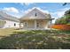 Expansive backyard featuring a covered patio, manicured lawn, and privacy fence at 23 N Edwards St, Plant City, FL 33563