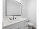 Modern bathroom featuring white vanity with black hardware, and sleek fixtures at 23 N Edwards St, Plant City, FL 33563